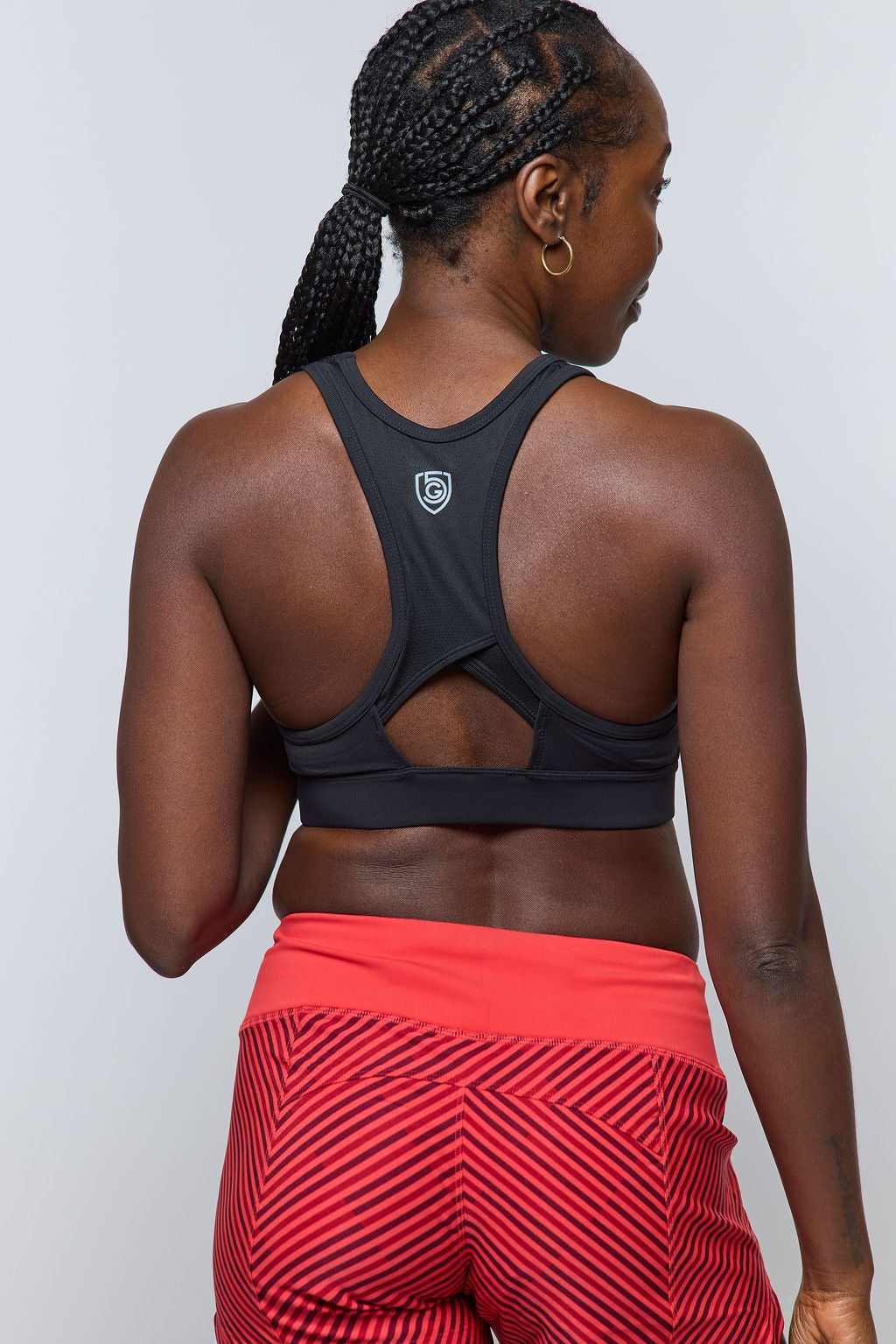 Woman wearing Excel Sculpt performance shorts and a sports bra, showcasing activewear designed for confidence.