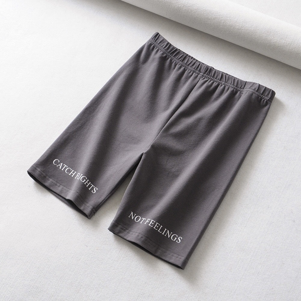 AlphaFlex Performance Training Shorts in gray featuring 'CATCHFLIGHTS' and 'NOTFEELINGS' lettering.