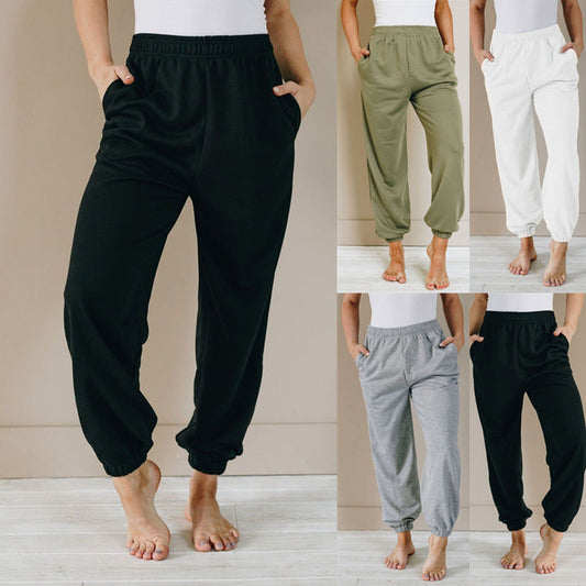 Women wearing solid color loose high waist sweatpants in casual sports style