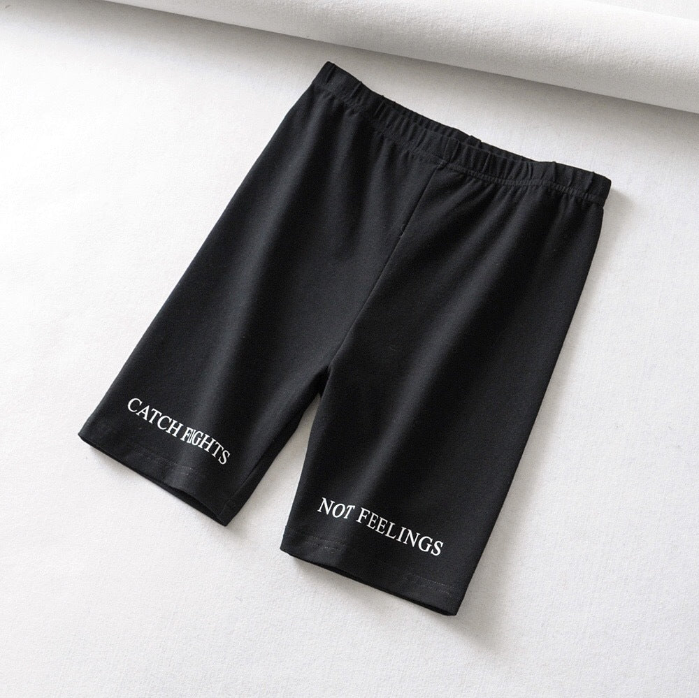 AlphaFlex Performance Training Shorts in black with text 'CATCH FIGHTS' and 'NOT FEELINGS' on the legs.