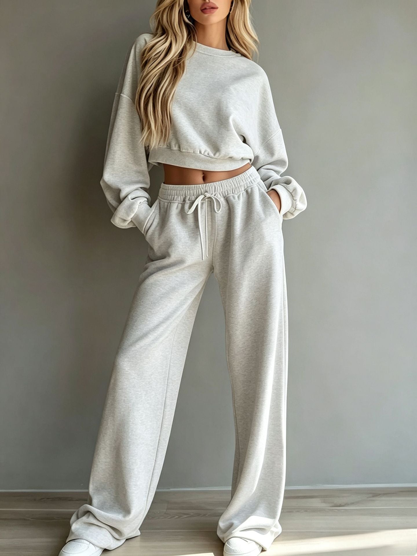 Woman wearing light yellow casual short hooded sweatshirt and wide-leg pants set