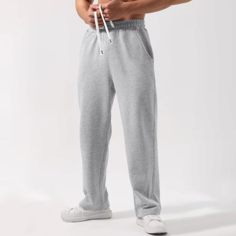 Black male solid color elastic-waist drawstring sweatpants in loose fit wide-leg style
