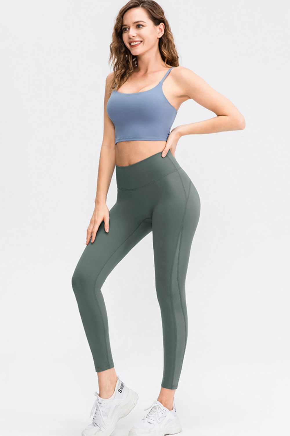 CoreLift Wide-Waist Performance Leggings in green on a model, showcasing stylish fitness wear for active lifestyles.