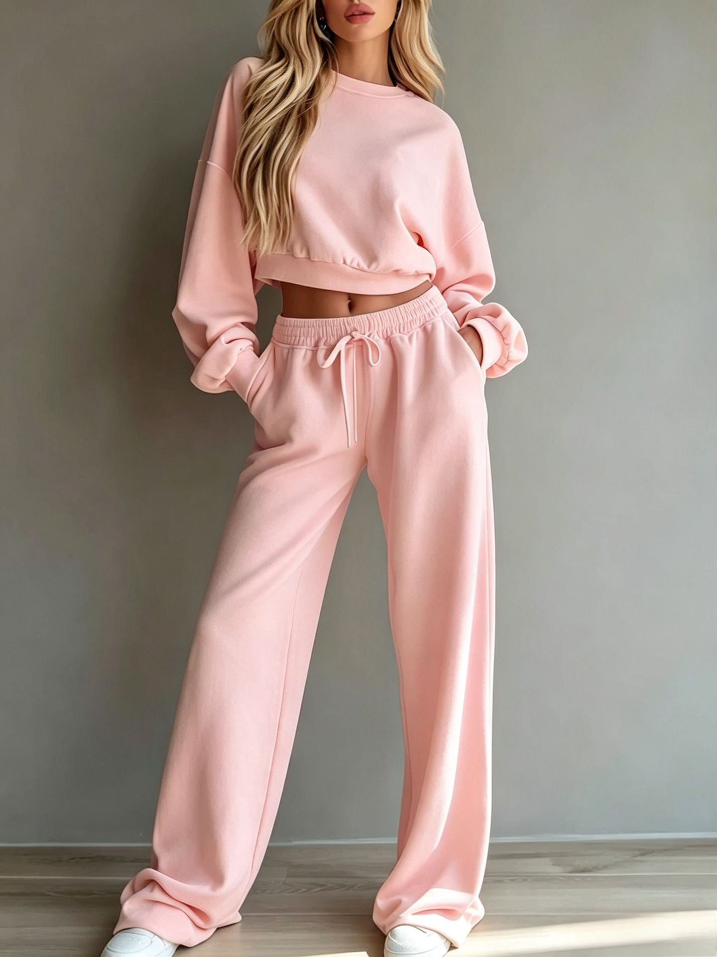 Woman wearing casual short hooded sweatshirt and wide-leg pants set in light yellow polyester fabric