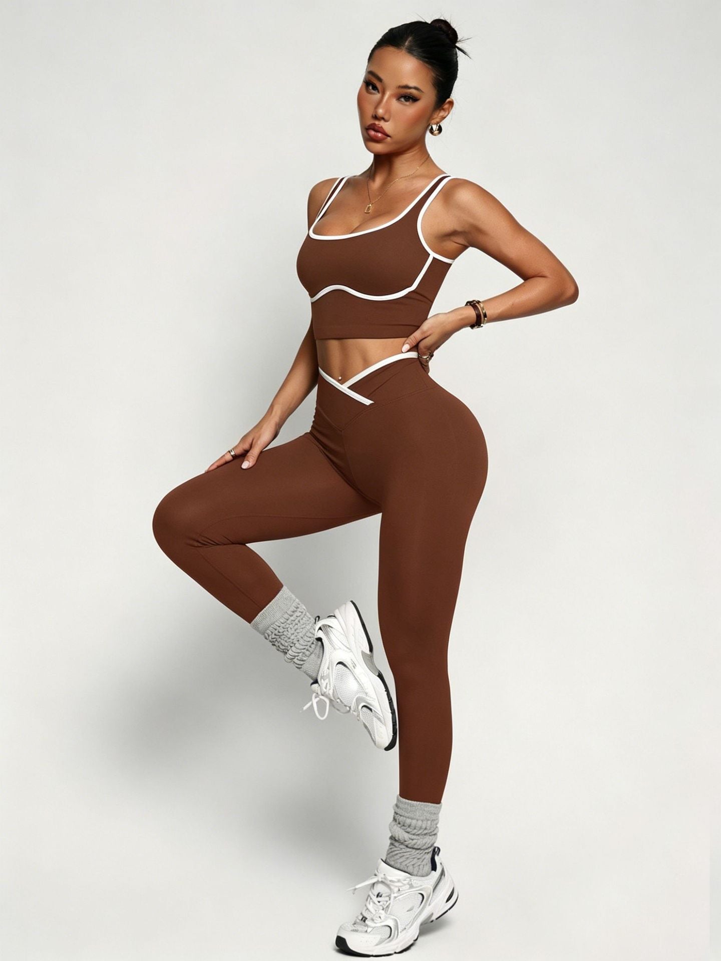 Young woman wearing black women's workout outfit set with sports bra and high waist yoga pants