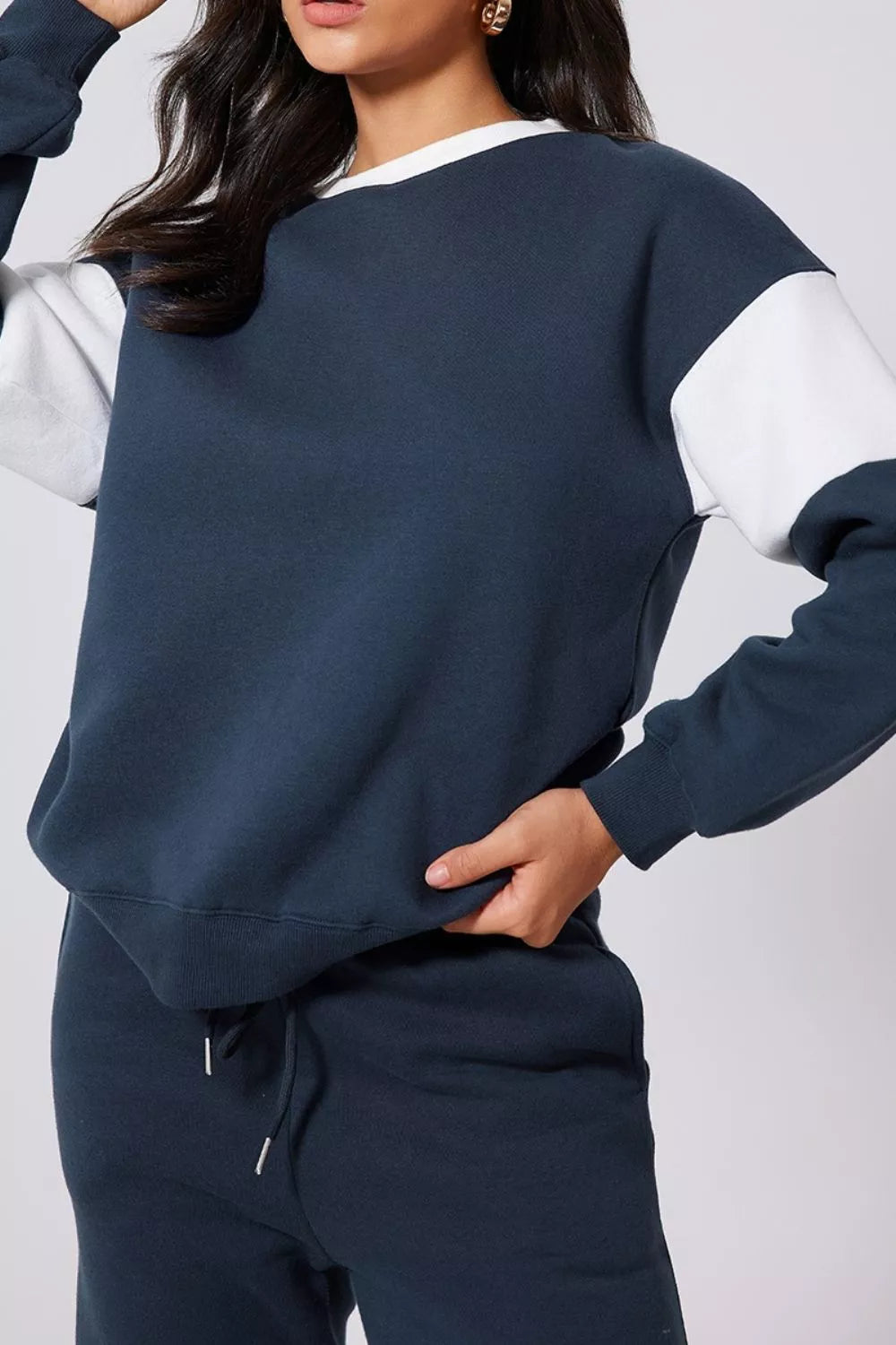 Model wearing MotionFlex Sweatshirt showcasing relaxed fit and modern style in navy blue.