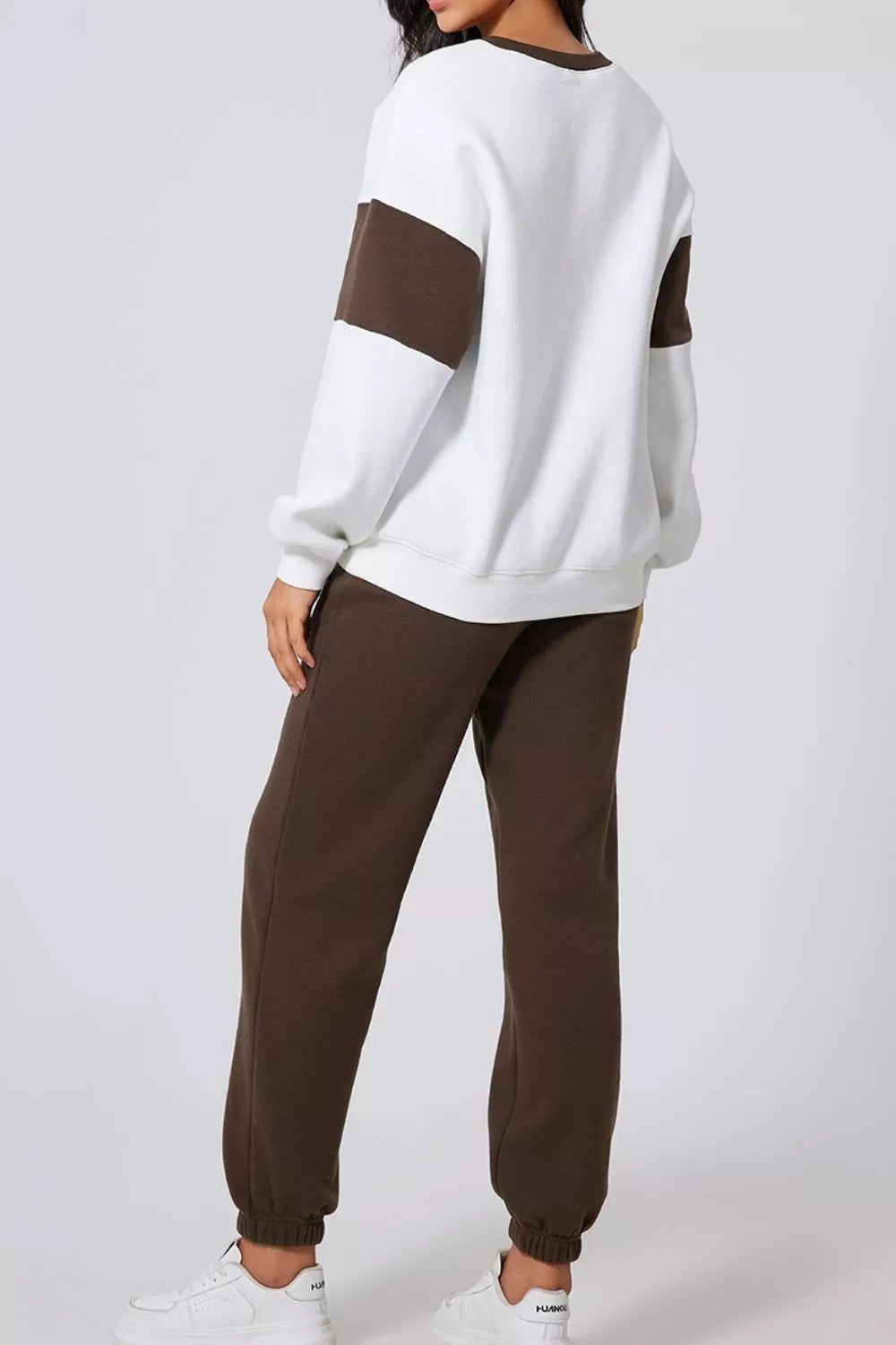 Model wearing MotionFlex Sweatshirt & Jogger Set, showcasing relaxed fit and modern athletic style.