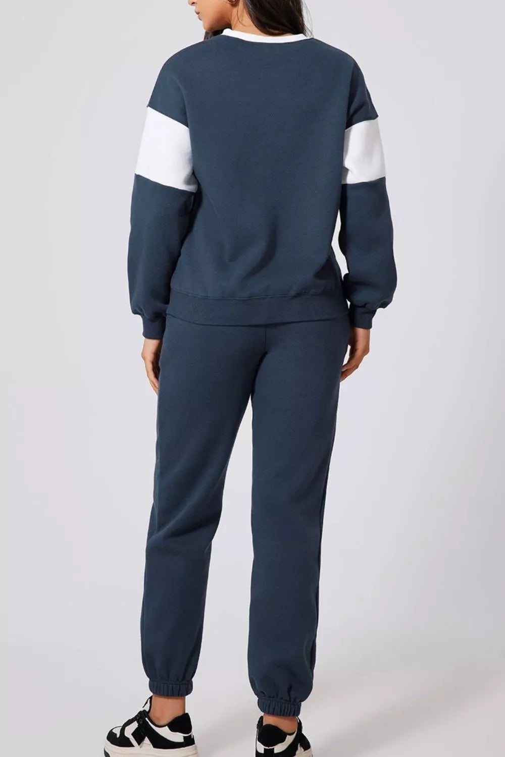 Back view of MotionFlex Sweatshirt & Jogger Set in navy with white accents, showcasing relaxed fit and athletic style.