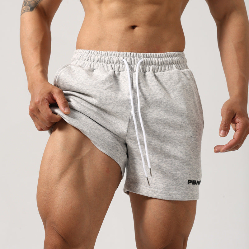 Men's black mid-waist padded workout shorts in cotton fabric
