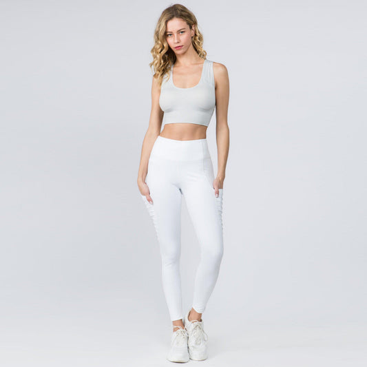 Model wearing ContourFlex leggings and a crop top, showcasing the sleek design and flexibility of high-waist performance leggings.