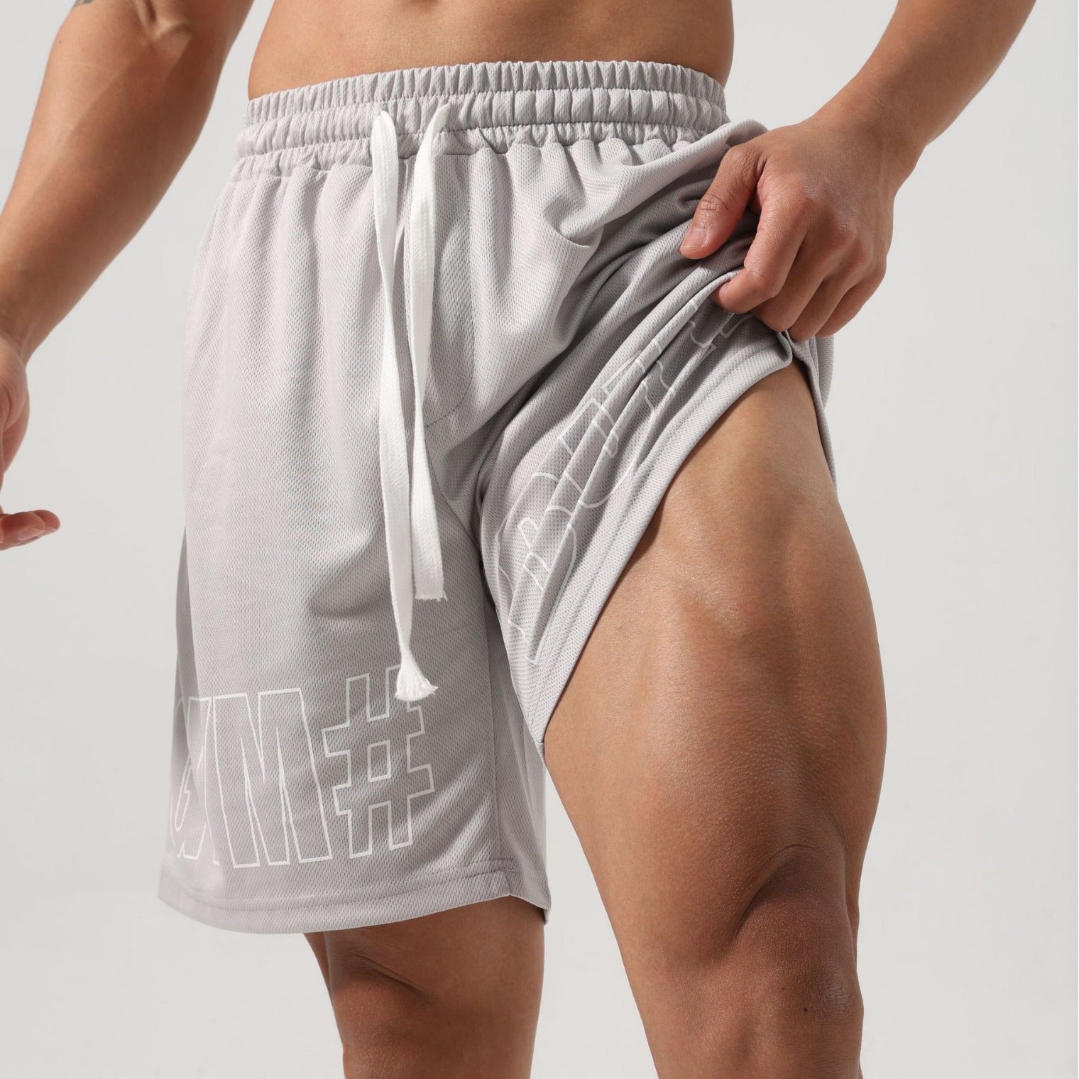 Men wearing fitness breathable ice silk sports shorts in black and gray colors