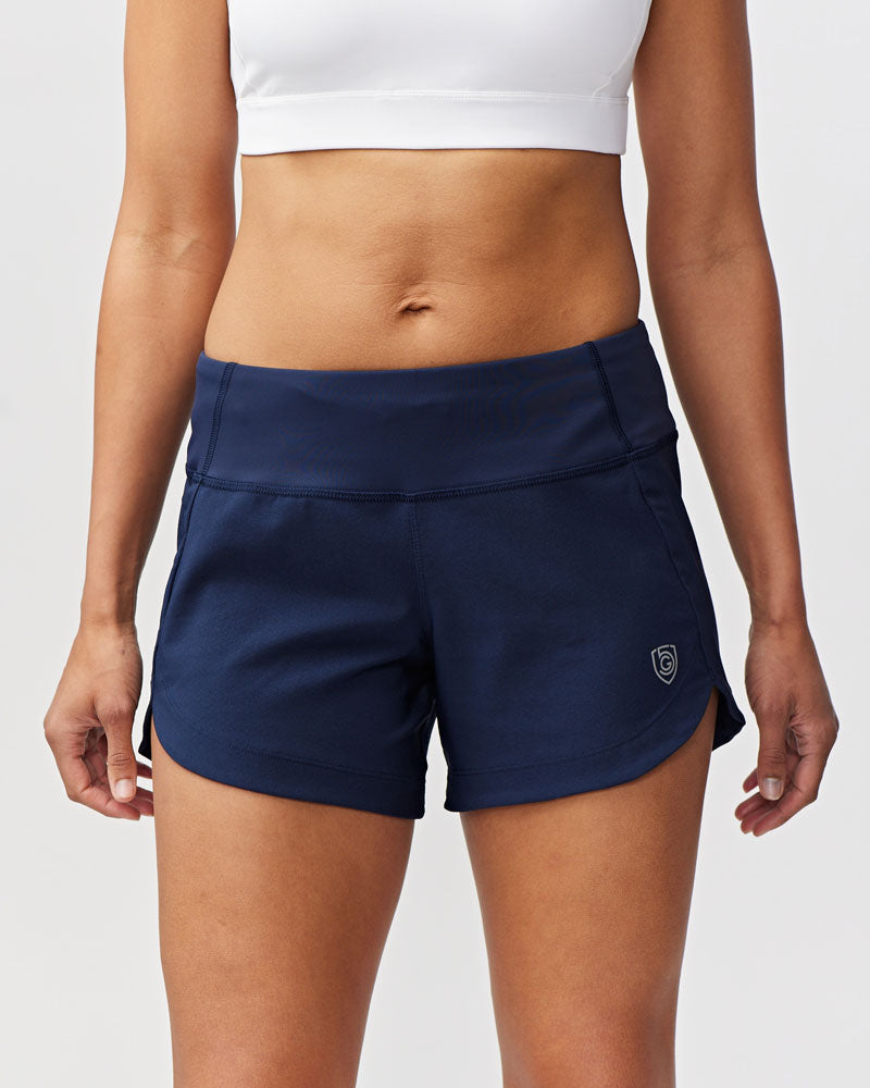 Model wearing Excel Sculpt Performance Shorts in navy blue, designed for active movement and comfort.