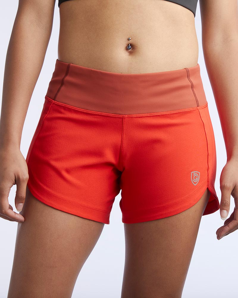Excel Sculpt Performance Shorts in vibrant orange, designed for confident movement and optimal comfort.