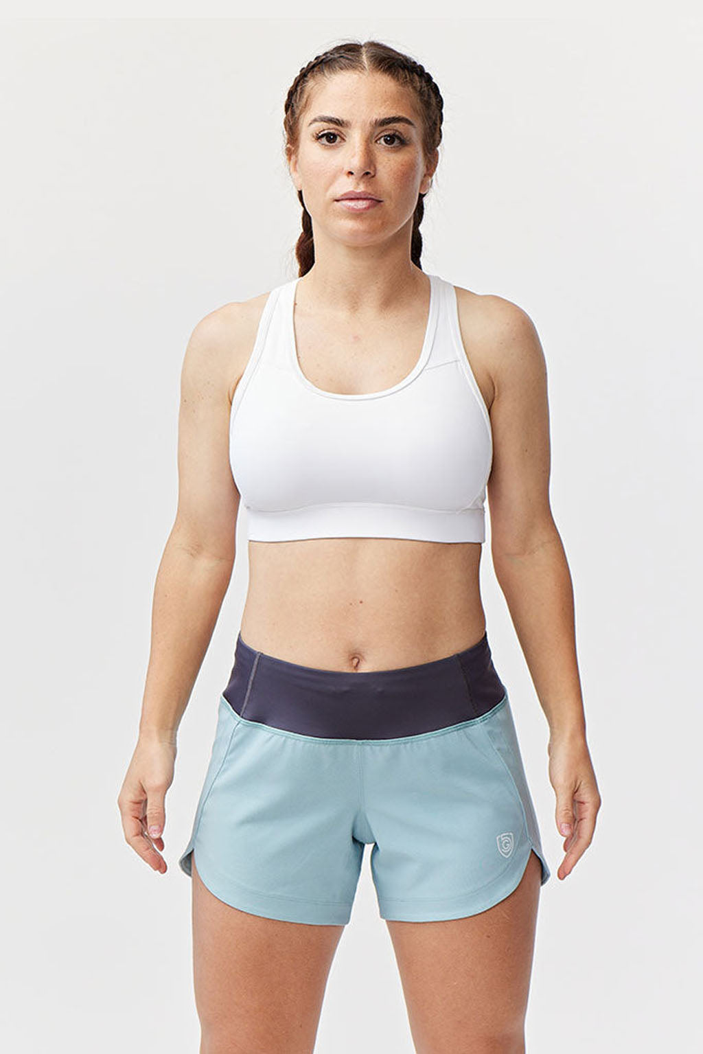 Model wearing Excel Sculpt Performance Shorts in light blue, showcasing confidence and style for active wear.