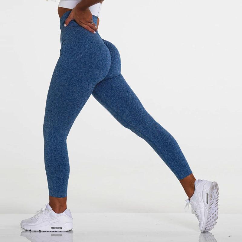 Model wearing SculptFlex Seamless High-Waist Performance Leggings in blue, showcasing a flattering fit and style.