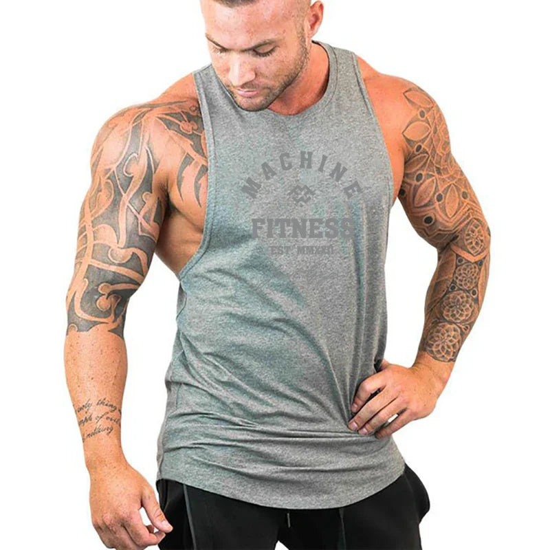 FlexFit Cotton Performance Tank worn by muscular man with tattoos, showcasing comfort and mobility during workout.