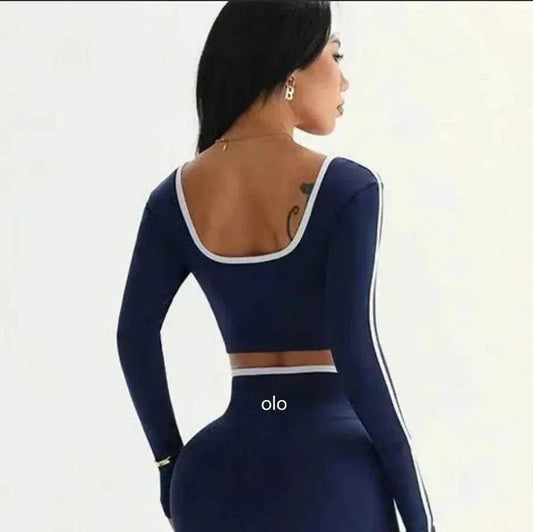 Woman wearing 2026 Colorblock V-Waist Yoga Set with long-sleeve colorblock top and high-rise V-waist leggings for yoga and workouts