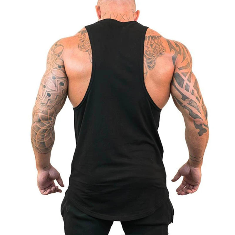 Back view of a muscular man wearing a FlexFit Cotton Performance Tank, showcasing its sleeveless design and comfort.