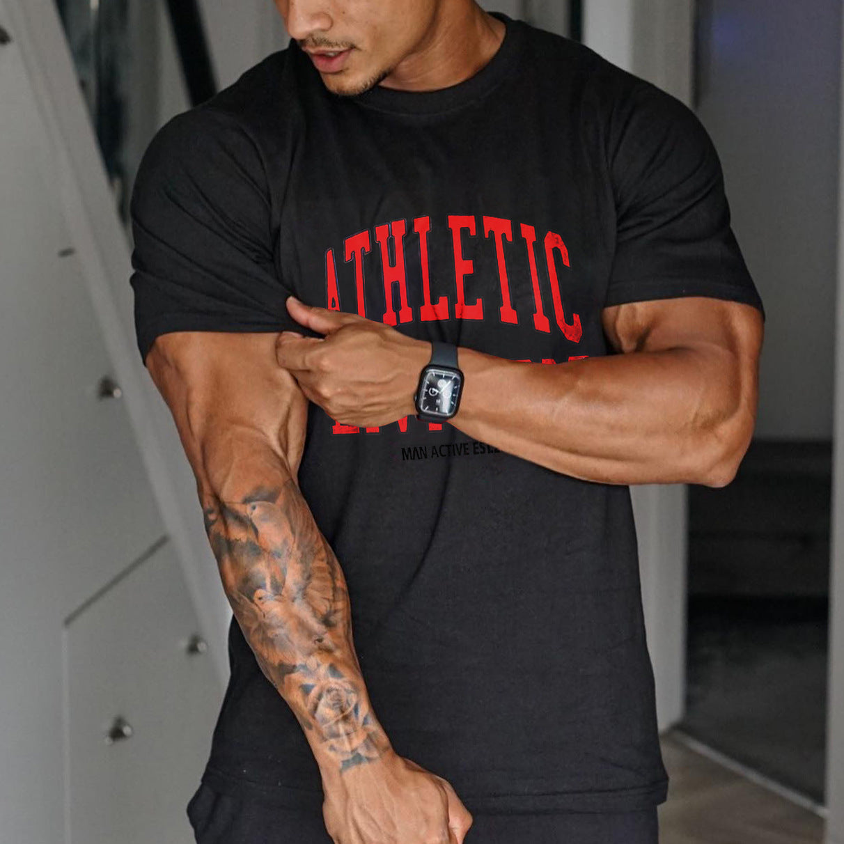 Men wearing trendy workout short sleeve T-shirt in black and white colors for athletic activities