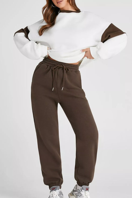 Model wearing MotionFlex Sweatshirt and matching joggers in stylish activewear set for comfort and movement.