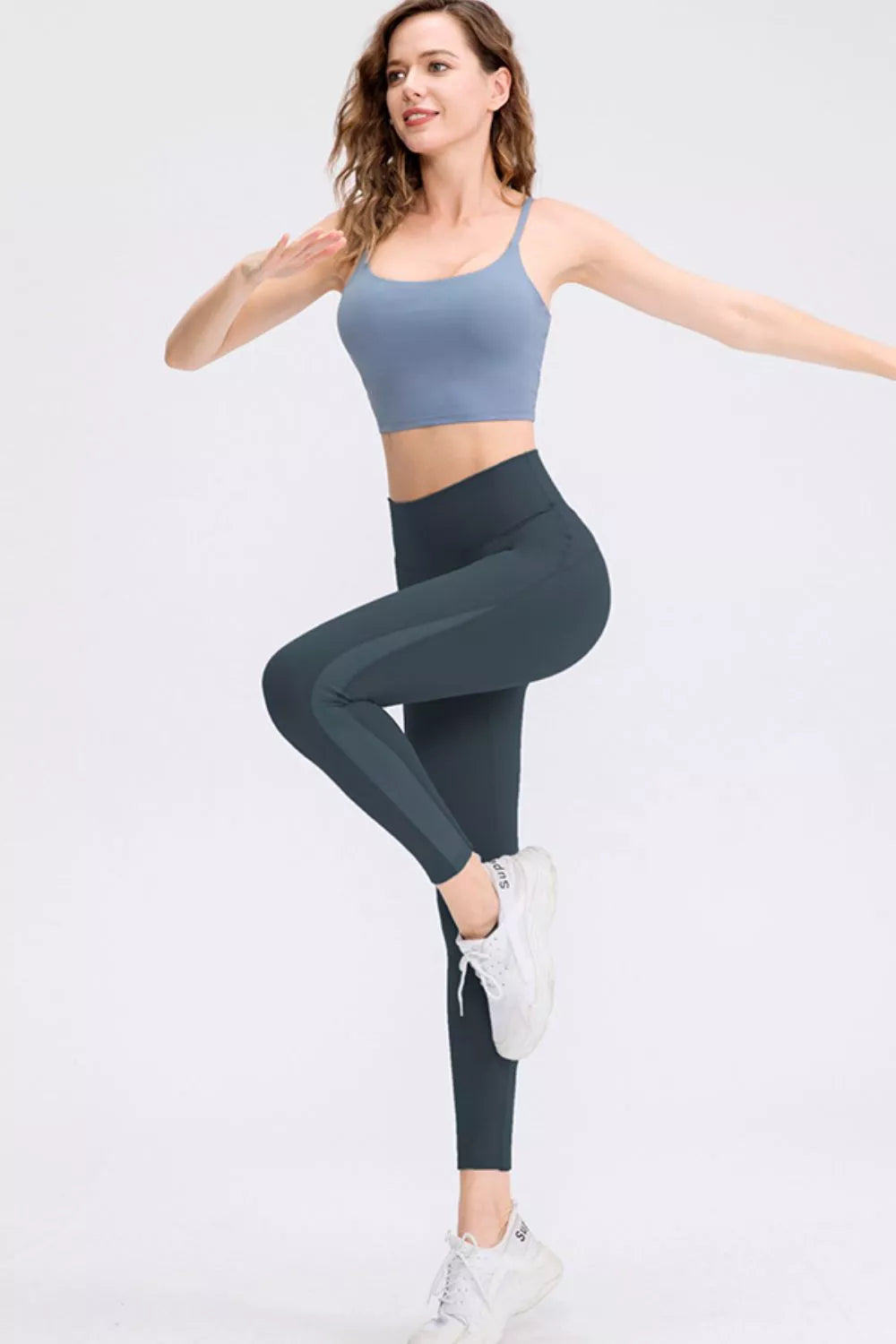 CoreLift Wide-Waist Performance Leggings on a model posing in activewear for fitness.