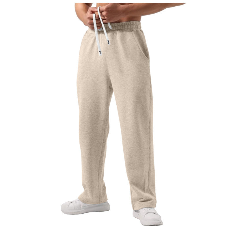 Men's elastic-waist drawstring sweatpants in solid colors with wide-leg loose fit and natural waist