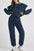 Model wearing MotionFlex Sweatshirt & Jogger Set in navy, showcasing relaxed fit and modern athletic style.