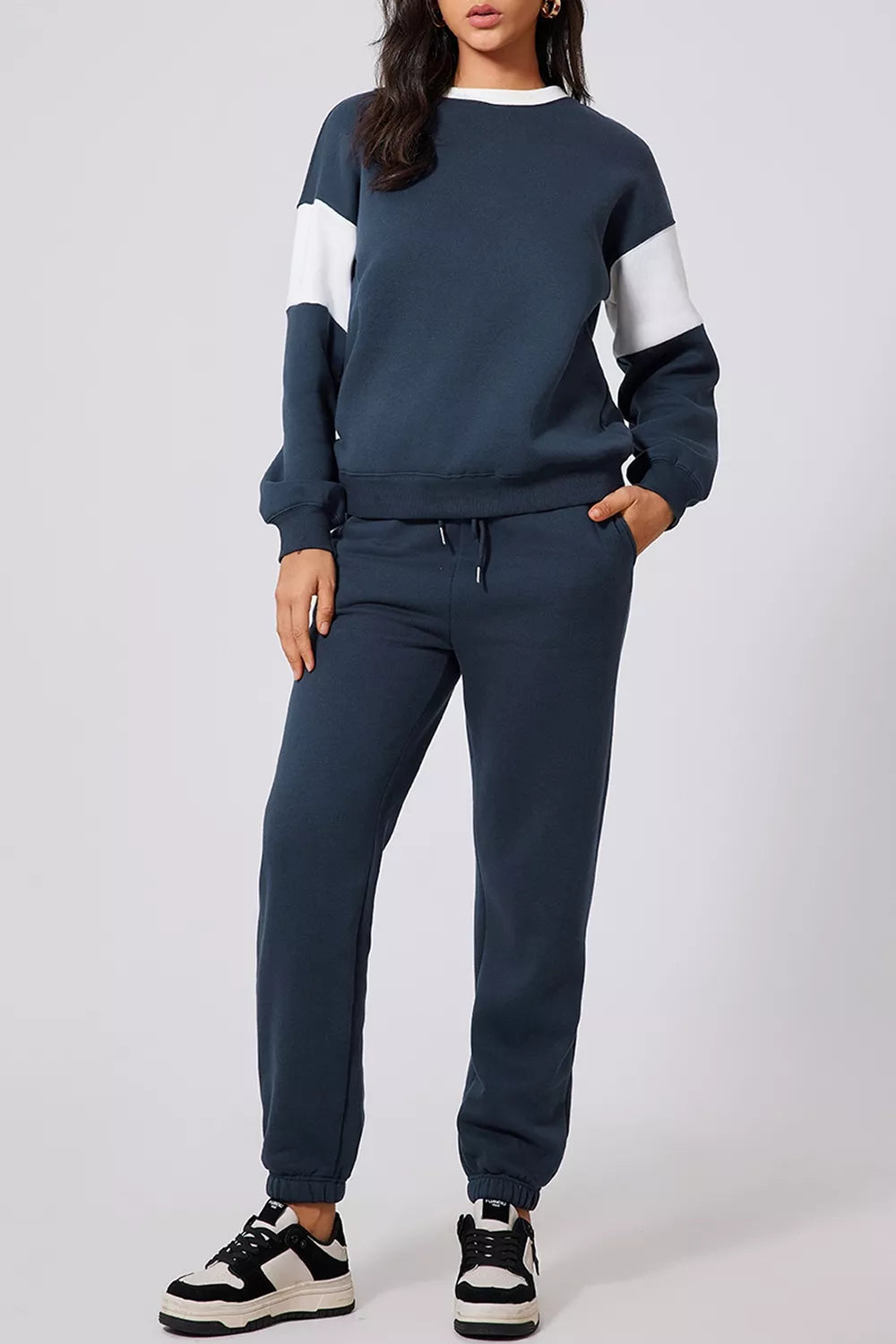 MotionFlex Sweatshirt and Jogger Set in navy blue, featuring a relaxed fit and stylish design for activewear.