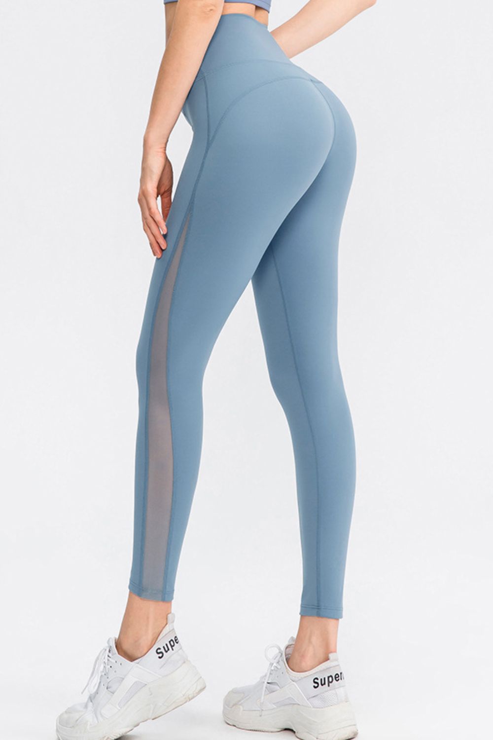 CoreLift Wide-Waist Performance Leggings in blue with mesh panels, designed for enhanced comfort and style during workouts.
