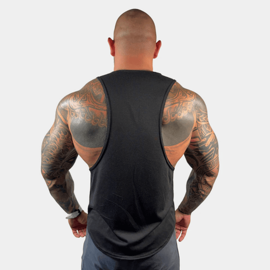 Muscular man showcasing the back view of the AeroFlex Drop Arm Training Tank, highlighting its design and fit.