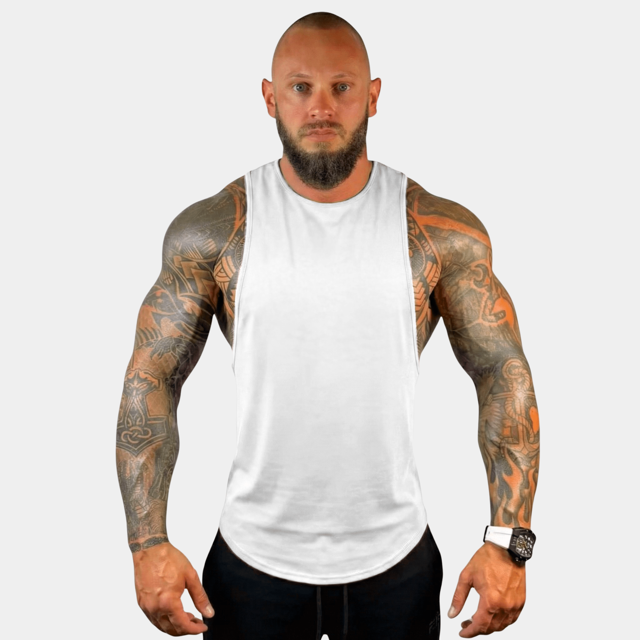 Fit man showcasing the AeroFlex Drop Arm Training Tank, emphasizing comfort and style for workouts.