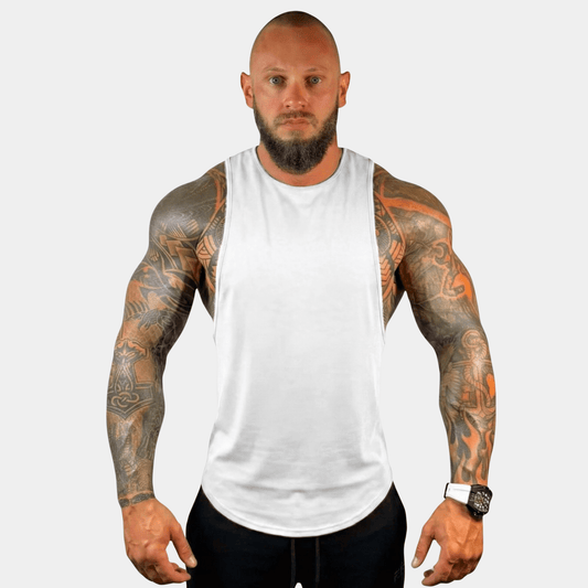 Fit man showcasing the AeroFlex Drop Arm Training Tank, emphasizing comfort and style for workouts.