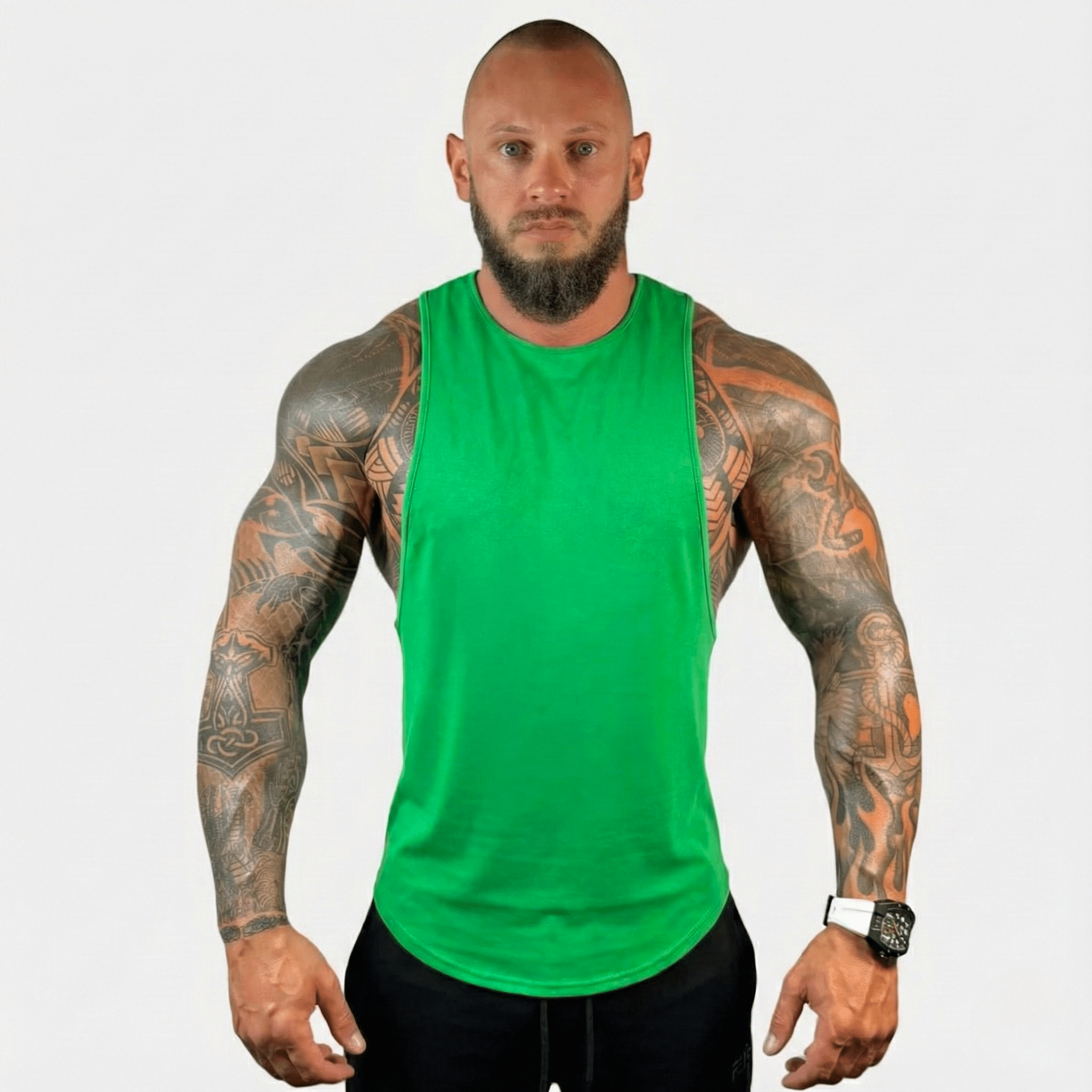 AeroFlex Drop Arm Training Tank on a muscular man, featuring a vibrant green color for elevated training style.