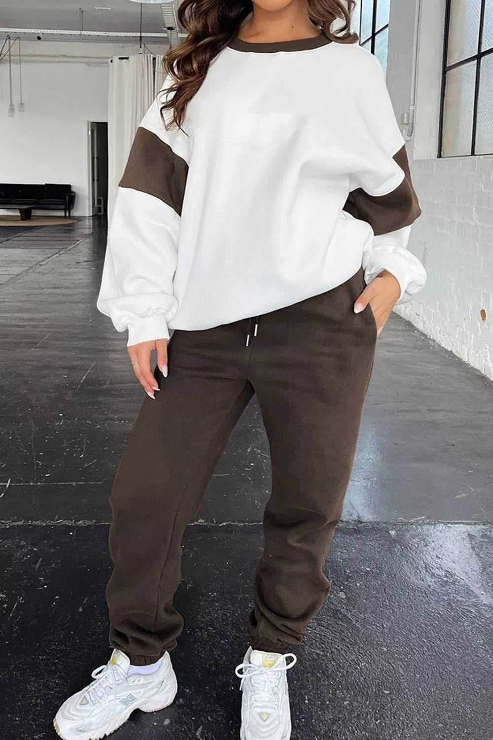 Model wearing MotionFlex Sweatshirt & Jogger Set featuring a relaxed fit and stylish color blocks.
