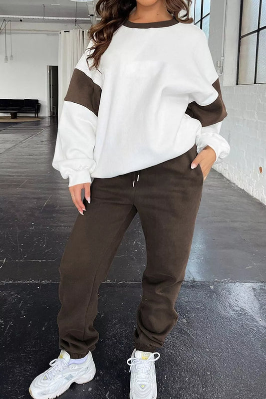 Model wearing MotionFlex Sweatshirt & Jogger Set featuring a relaxed fit and stylish color blocks.