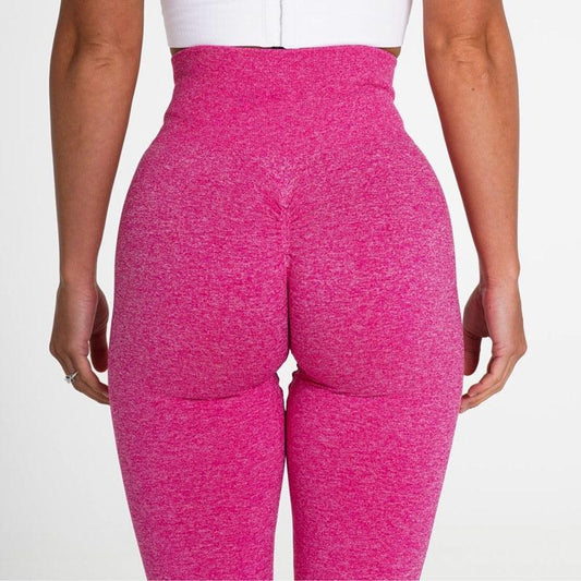 Rear view of a woman wearing SculptFlex Seamless High-Waist Performance Leggings in vibrant pink, showcasing a flattering fit.