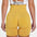 Back view of woman wearing FlexCurve Seamless High-Waist Sculpt Shorts in vibrant yellow.
