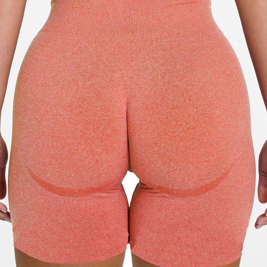 Back view of FlexCurve Seamless High-Waist Sculpt Shorts in coral color, highlighting smooth and flattering design.