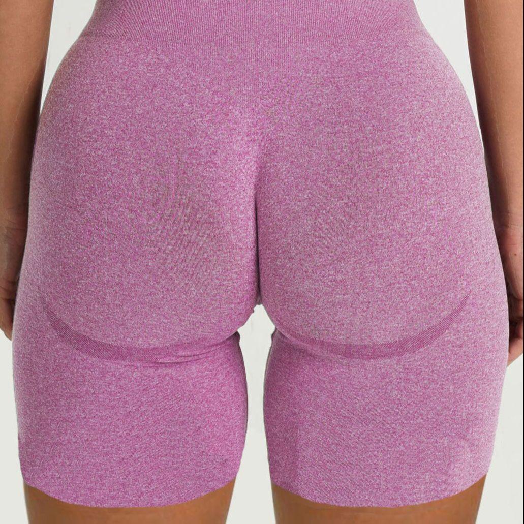 Back view of woman wearing FlexCurve Seamless High-Waist Sculpt Shorts in pink color.