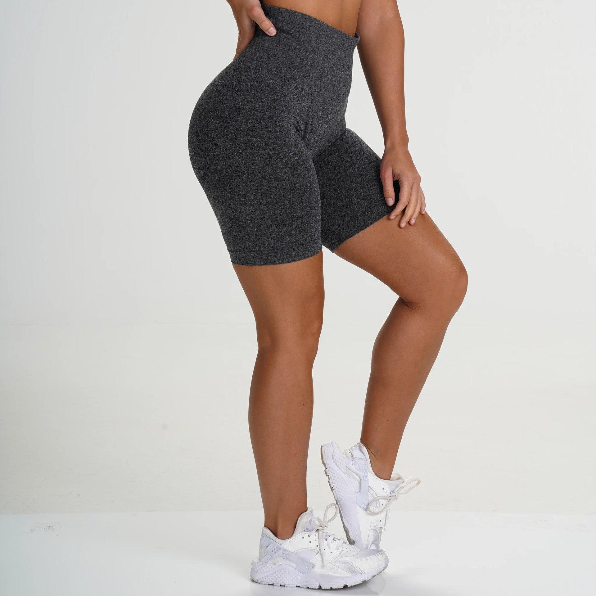 Model wearing FlexCurve Seamless High-Waist Sculpt Shorts in gray, showcasing a flattering fit and style.