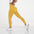 Model showcasing FlexCurve Seamless High-Waist Sculpt Shorts in vibrant yellow, highlighting fit and style.