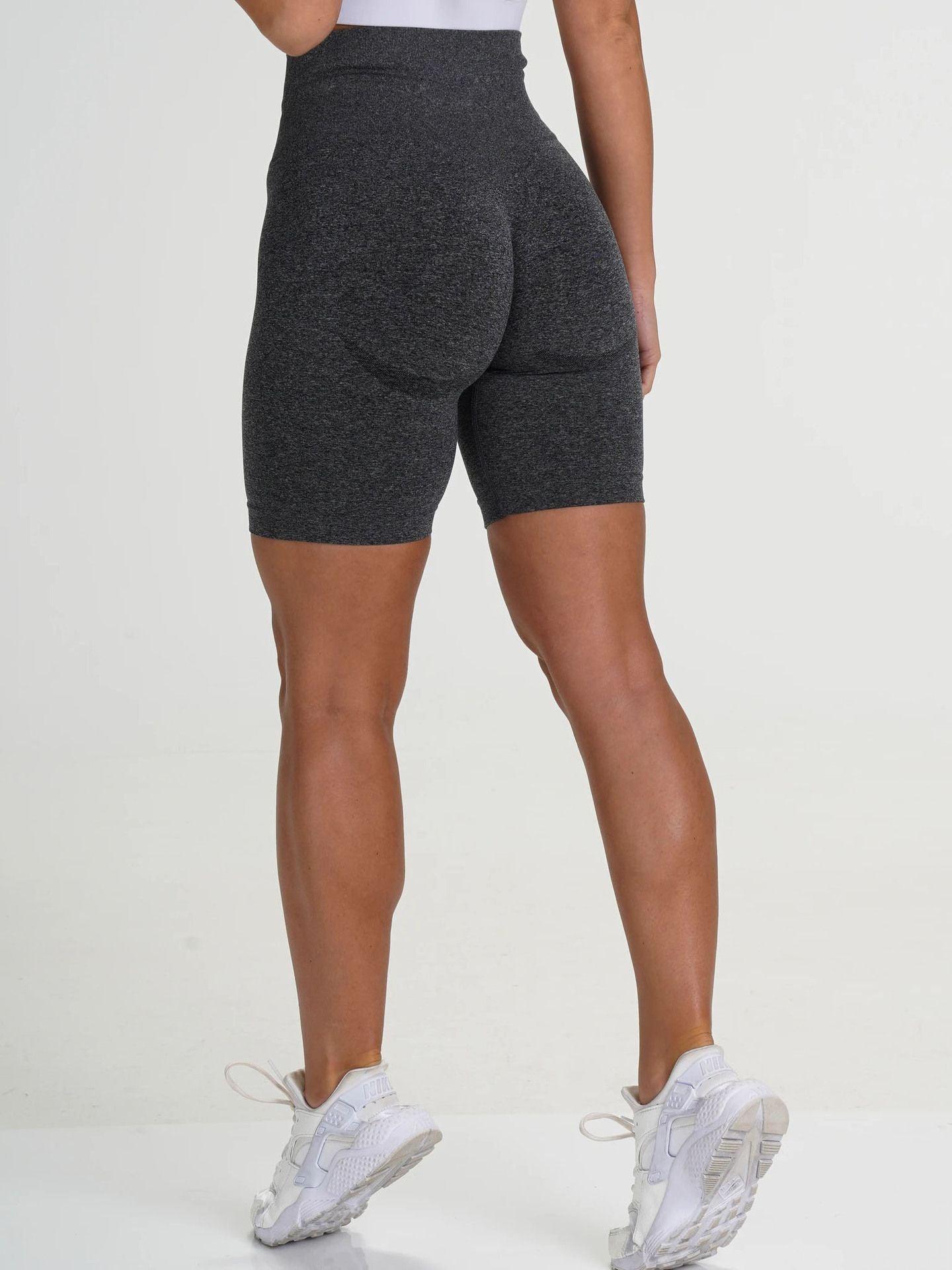 Rear view of model wearing FlexCurve Seamless High-Waist Sculpt Shorts in dark color, showcasing comfort and style.