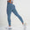 Model showcasing FlexCurve Seamless High-Waist Sculpt Shorts in blue, emphasizing a flattering fit and style.