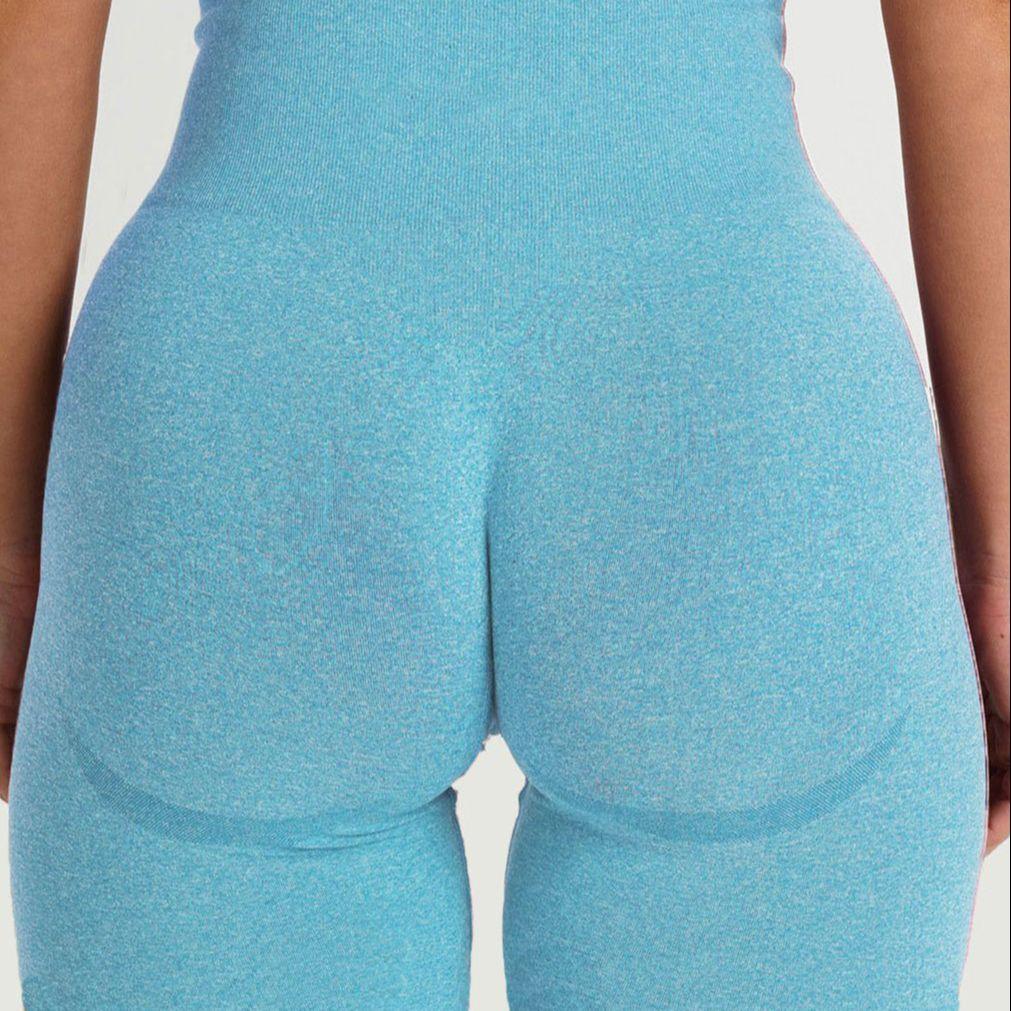Back view of a model wearing FlexCurve Seamless High-Waist Sculpt Shorts in blue, showcasing fit and comfort.